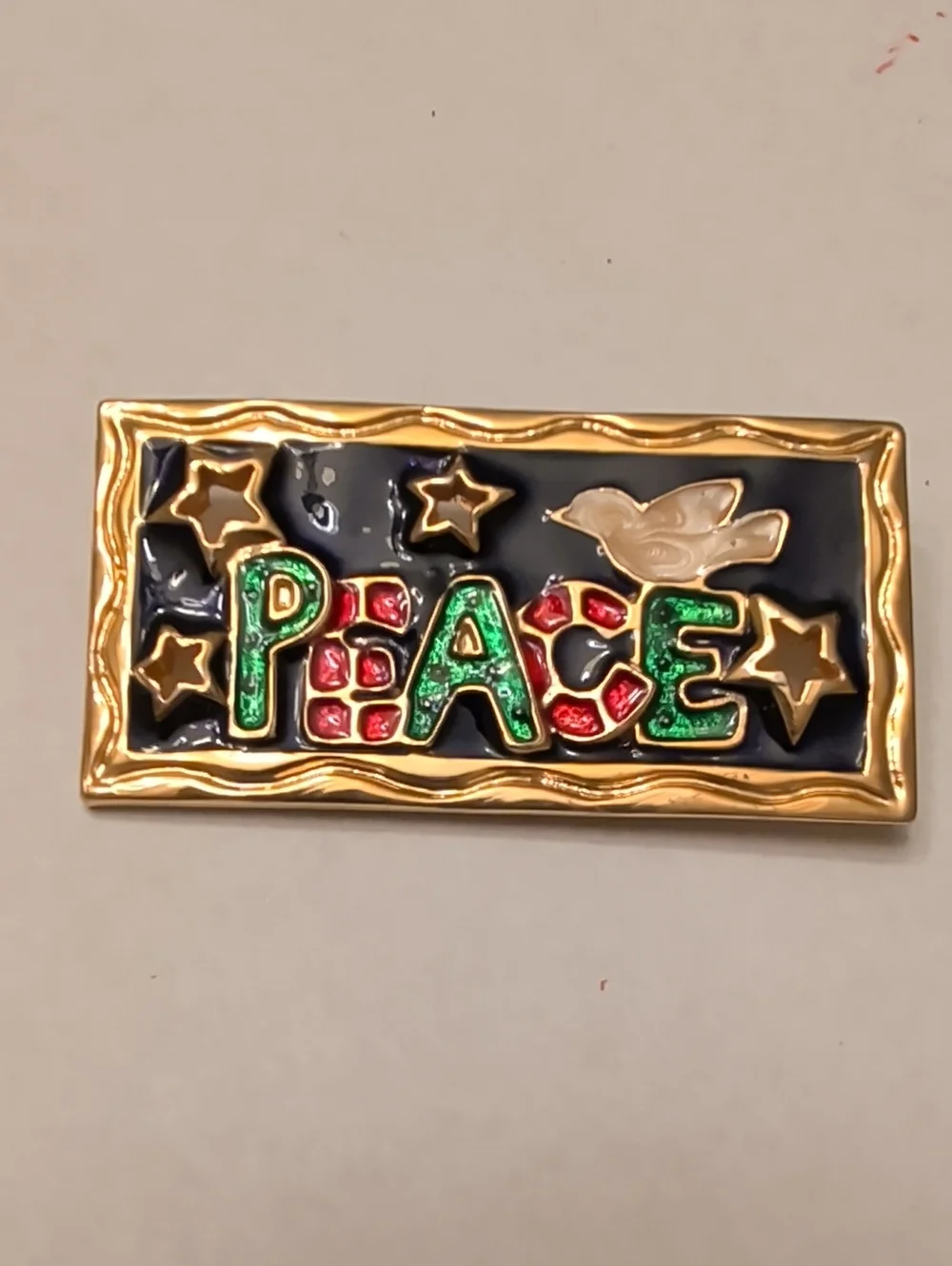 Gold-Trim 'PEACE' Brooch with Green and Red Accents
